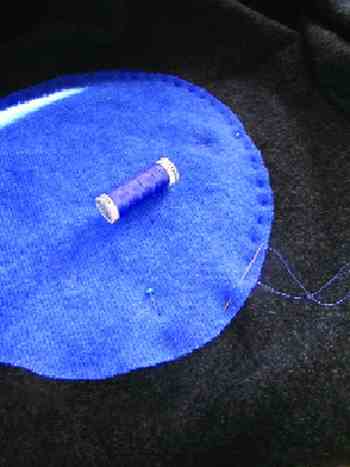 STEP 5: Use a needle and thread to hand-sew the circles onto the blanket. A simple running stitch goes quickly and holds well. Stitch about 1/4-inch ffrom the edge, all the way around the circle.